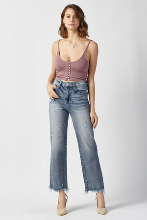 a woman in a tank top and jeans