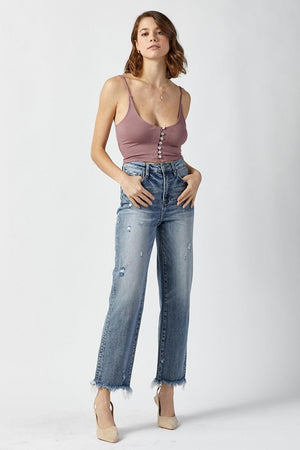 a woman in a tank top and jeans