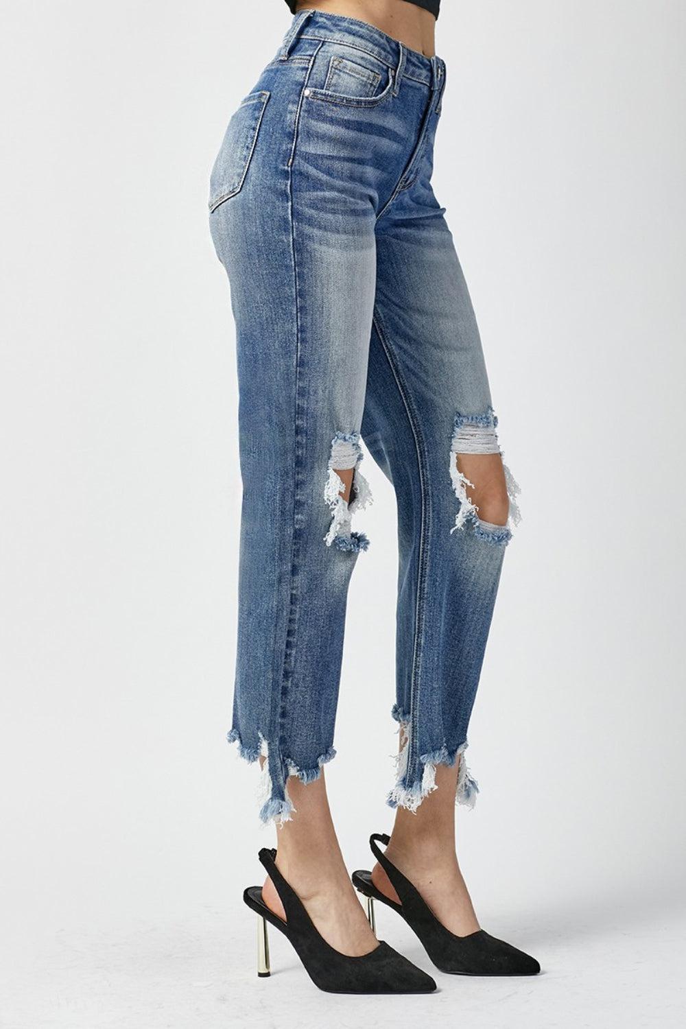 a woman wearing high heels and ripped jeans