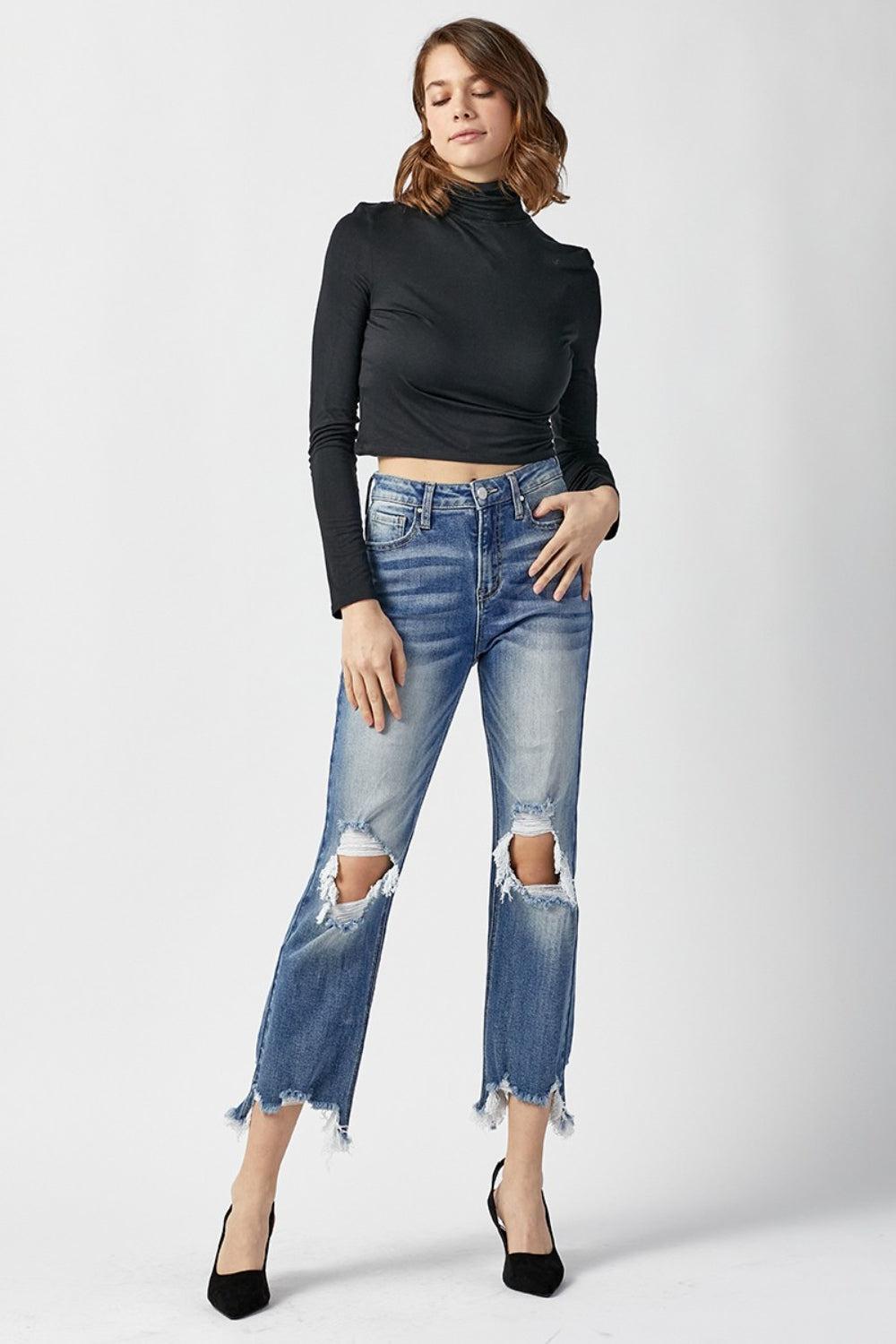 a woman in black shirt and jeans posing for a picture