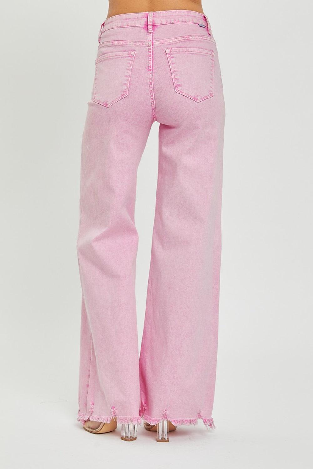 a woman is wearing pink jeans and heels