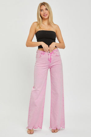 a woman in a black top and pink jeans