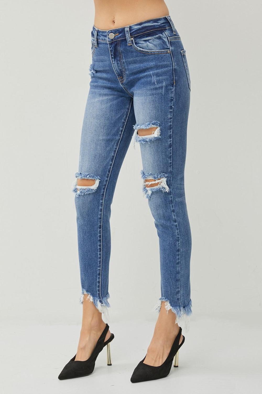 a woman in high heels is wearing a pair of ripped jeans