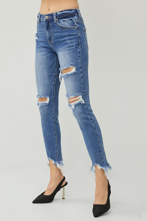 a woman wearing ripped jeans and heels