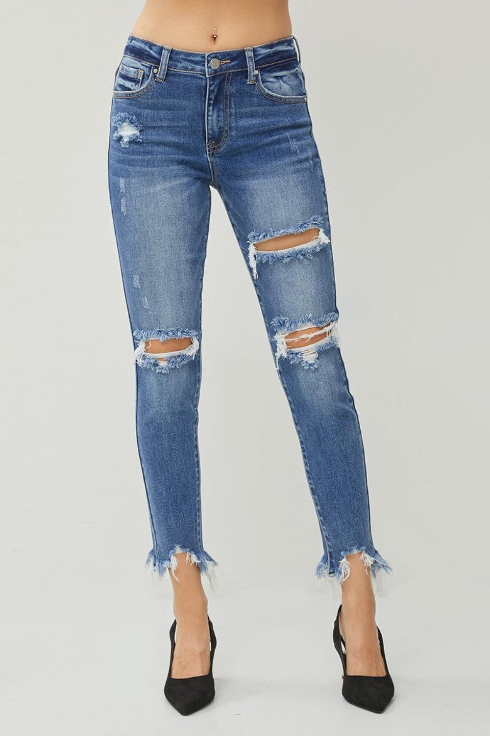 a woman wearing ripped jeans and heels