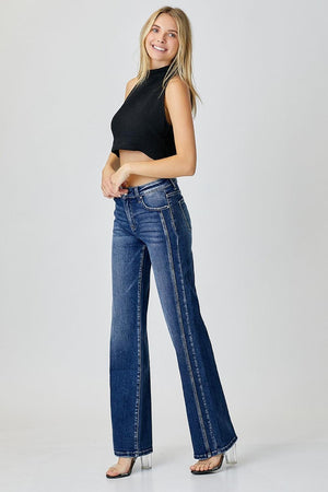 a woman in a black top and jeans posing for a picture