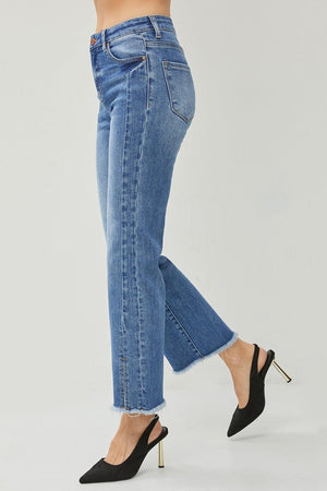 a woman wearing high heels and jeans