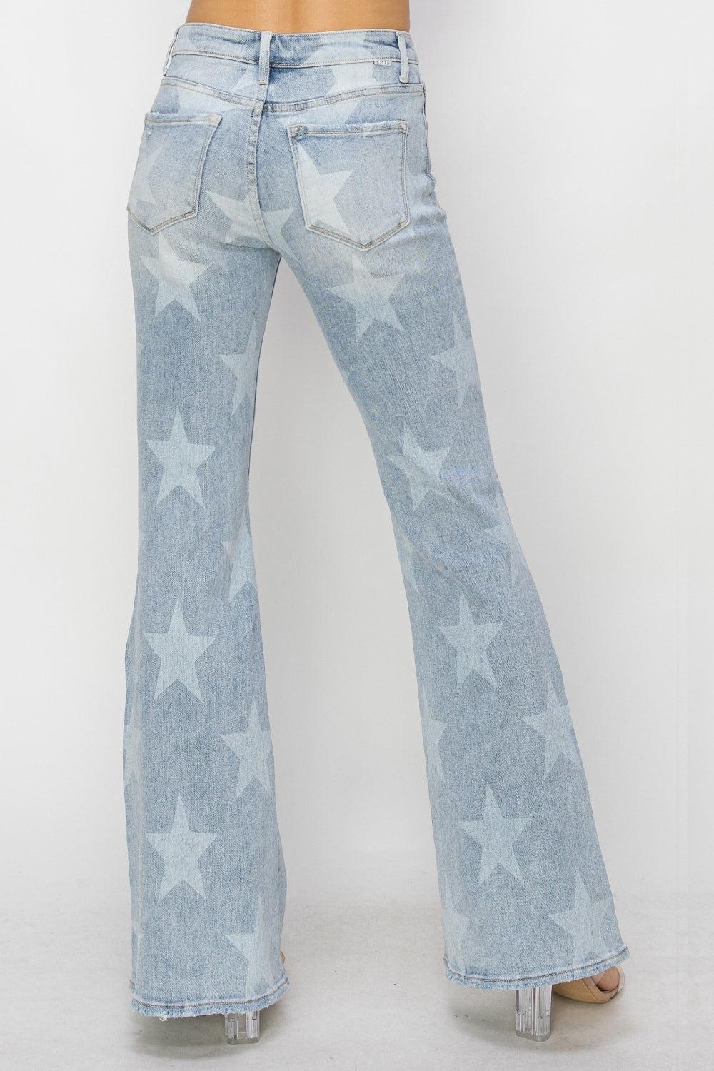 a woman wearing a pair of jeans with stars on them