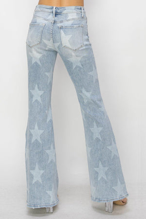 a woman wearing a pair of jeans with stars on them