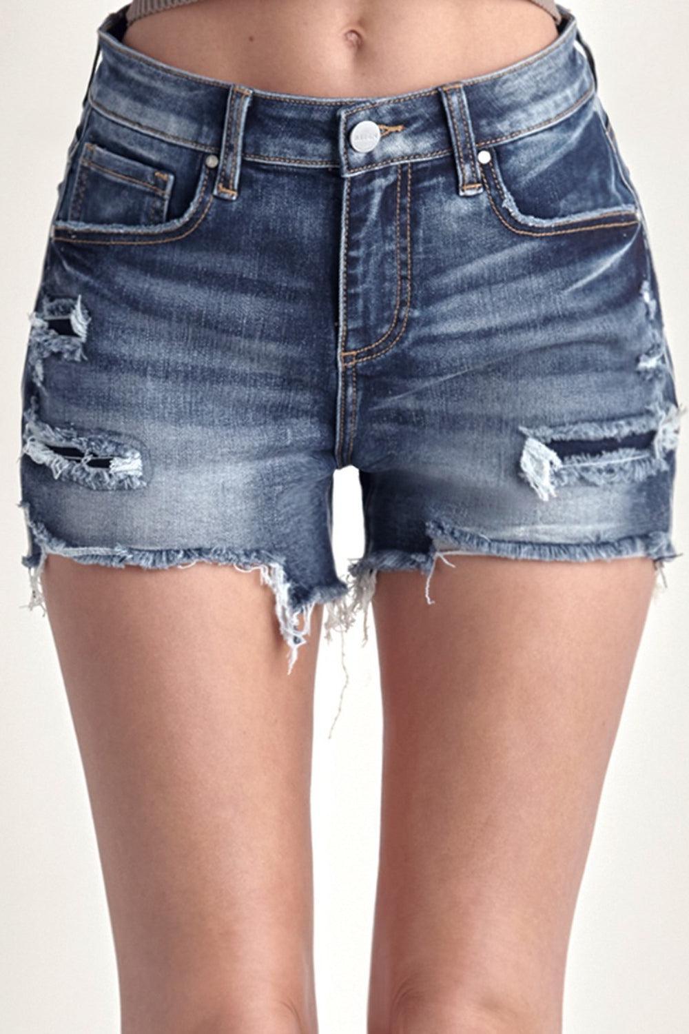 a woman wearing a pair of shorts with holes