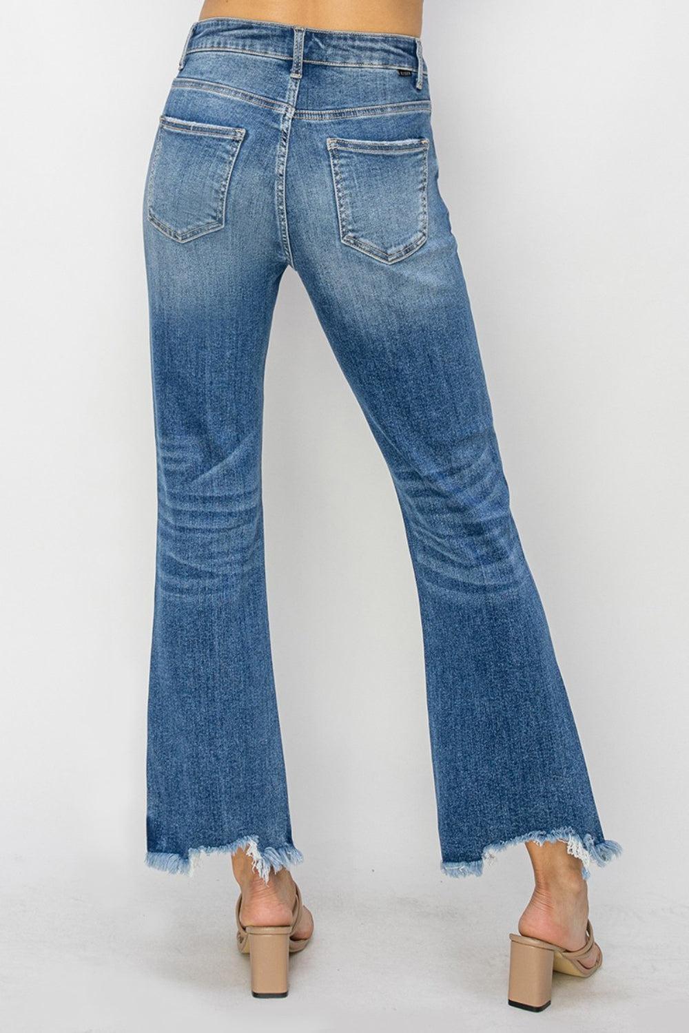 a woman wearing a pair of high rise jeans