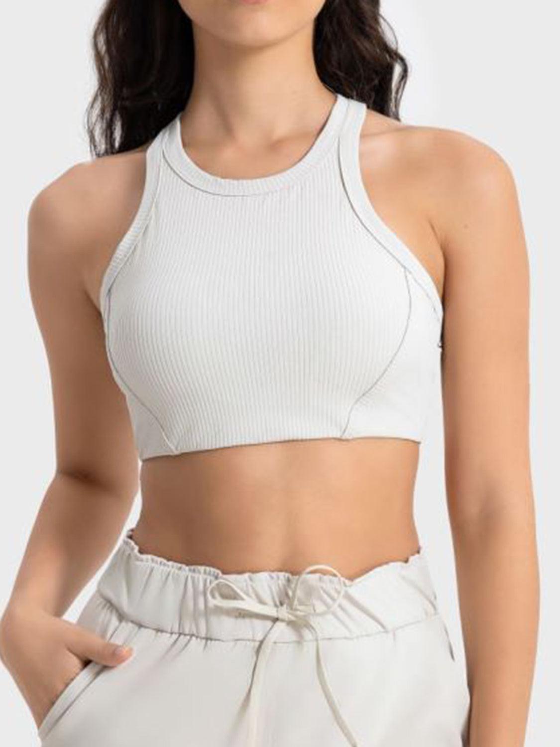 a woman wearing a white crop top and shorts