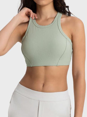 a woman wearing a green sports bra top