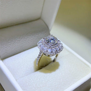 a diamond ring sits in a box on a table