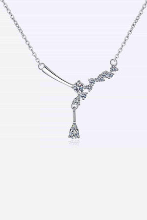 a white gold necklace with a dangling diamond