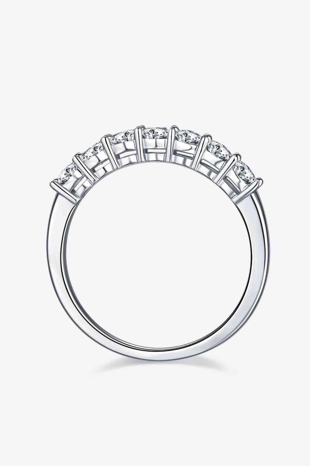 a white gold ring with five diamonds