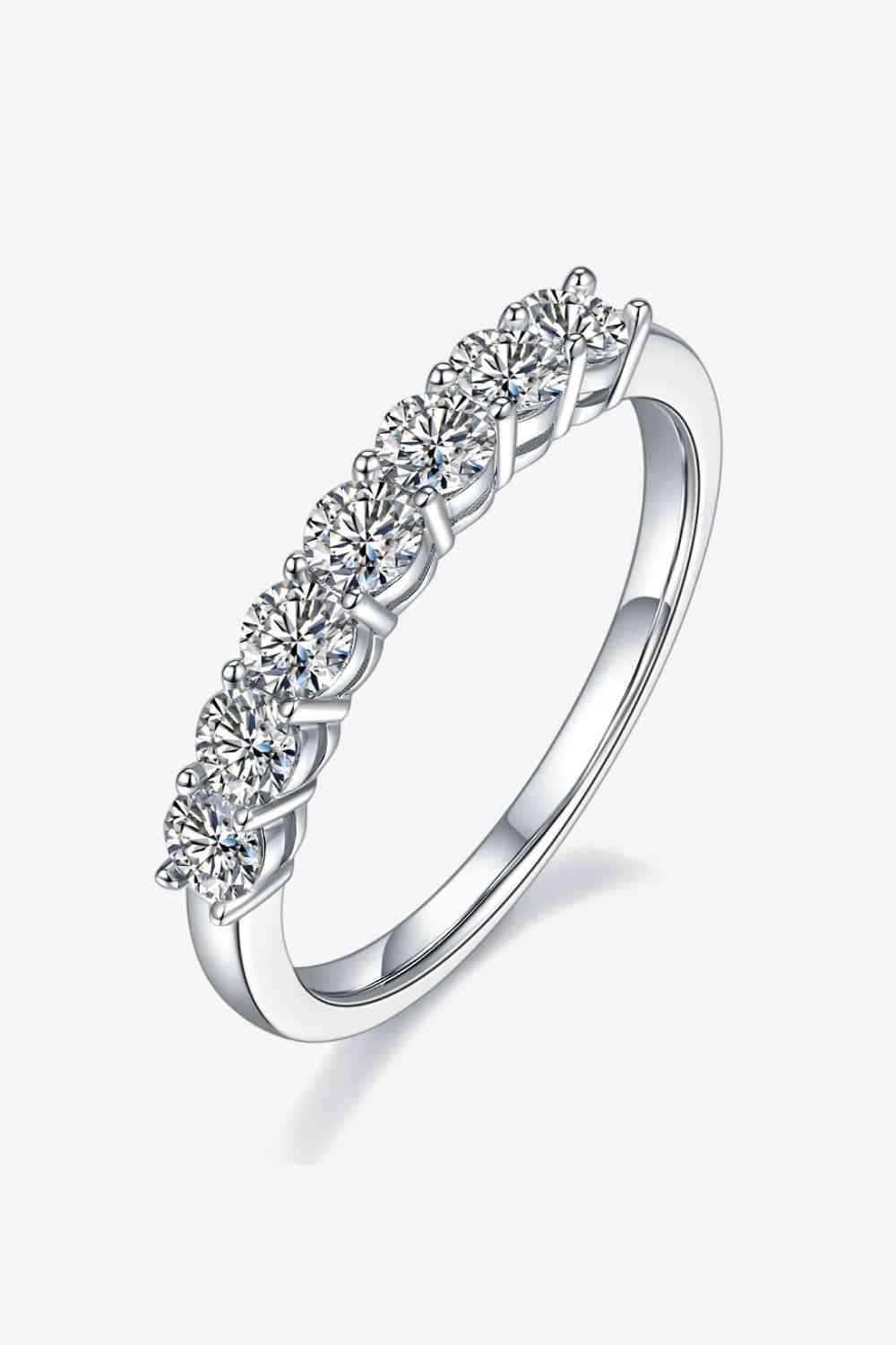 a white gold ring with five diamonds on it