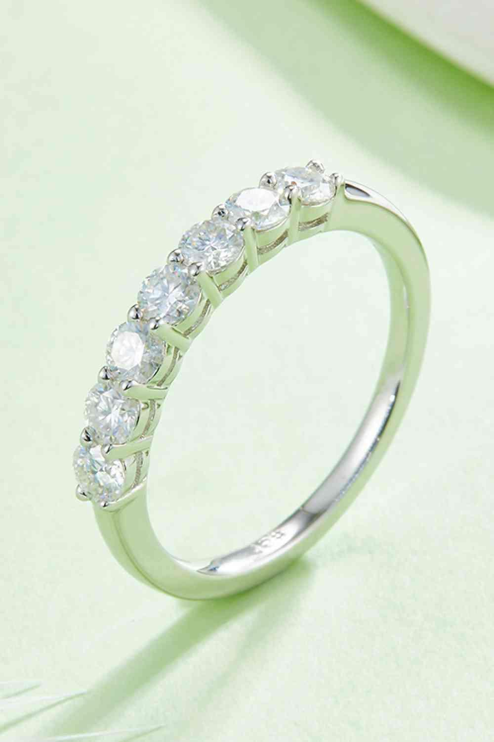 a white gold ring with five diamonds