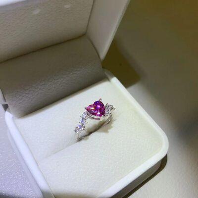 a pink heart shaped ring in a white box