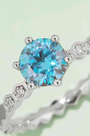 a ring with a blue topaz surrounded by diamonds