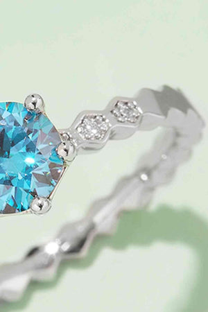 a ring with a blue topaz surrounded by diamonds