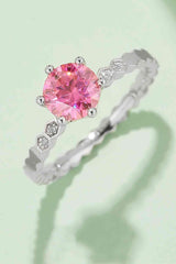 a ring with a pink diamond in the center