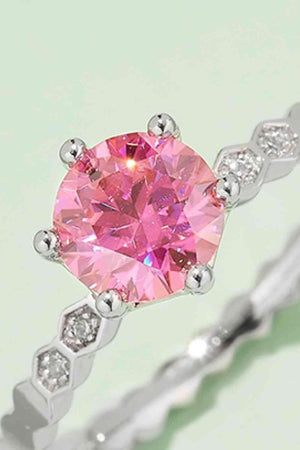 a pink diamond ring on a white background