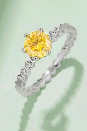 a yellow diamond ring on a green background