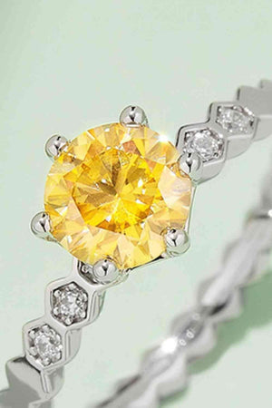 a yellow diamond ring with white diamonds