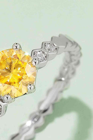 a fancy ring with a yellow diamond in the center