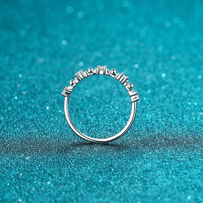 a diamond ring sitting on a blue surface