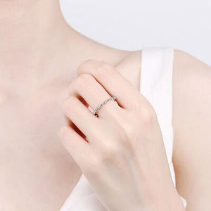 a woman wearing a diamond ring on her finger