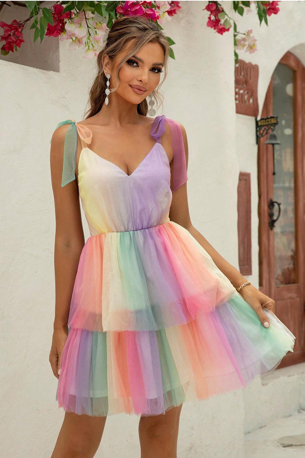 a woman in a multicolored dress posing for a picture