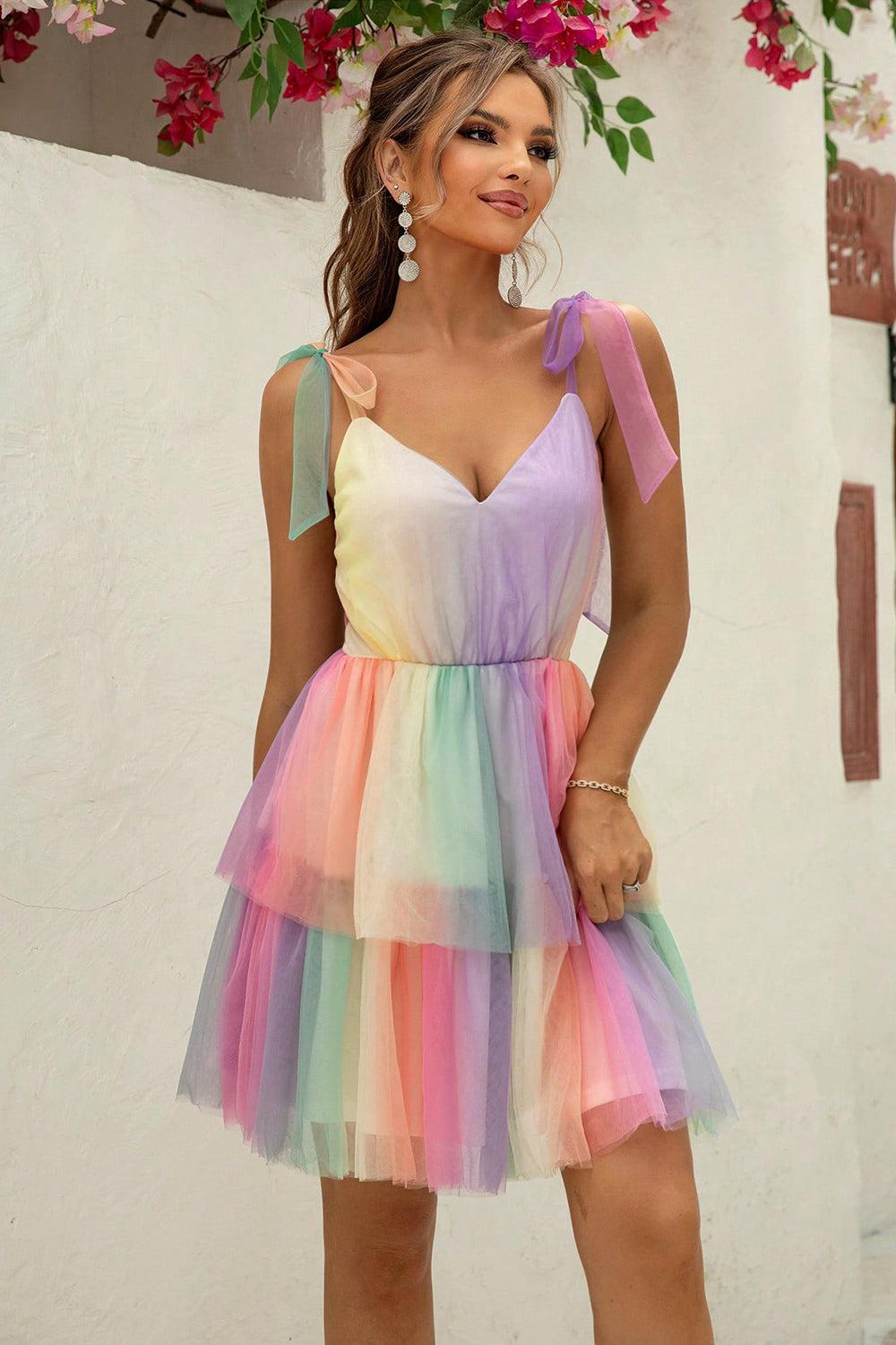 a woman in a multicolored dress posing for a picture