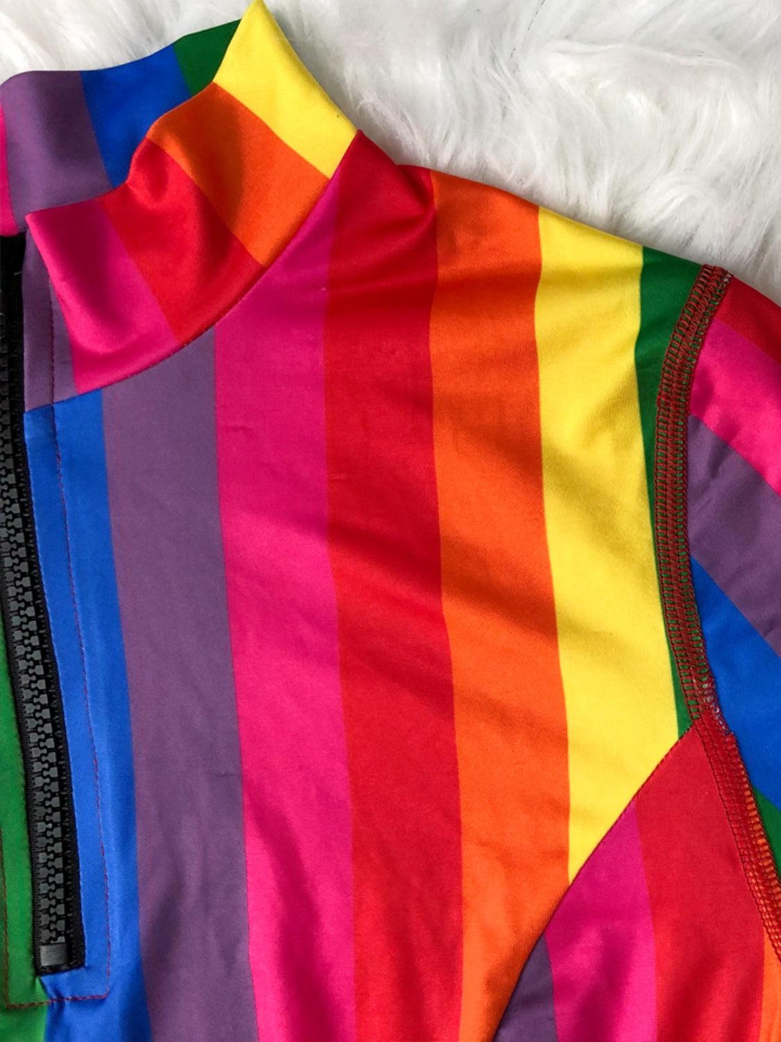 a multicolored jacket with zippers on a bed