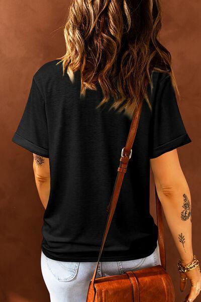 a woman wearing a black shirt carrying a brown bag