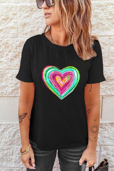 a woman wearing a black t - shirt with a colorful heart on it