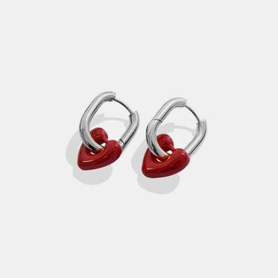 a pair of heart shaped earrings on a white background