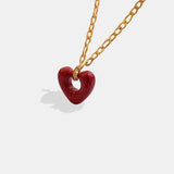 a necklace with a heart on a chain