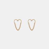 a pair of gold heart shaped earrings