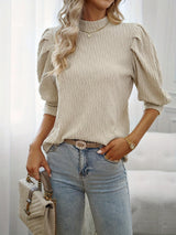 a woman wearing a white top and jeans