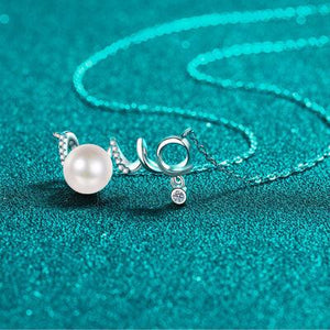 a necklace with a pearl on a chain