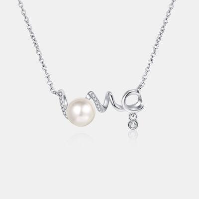 a white pearl and diamond necklace on a chain