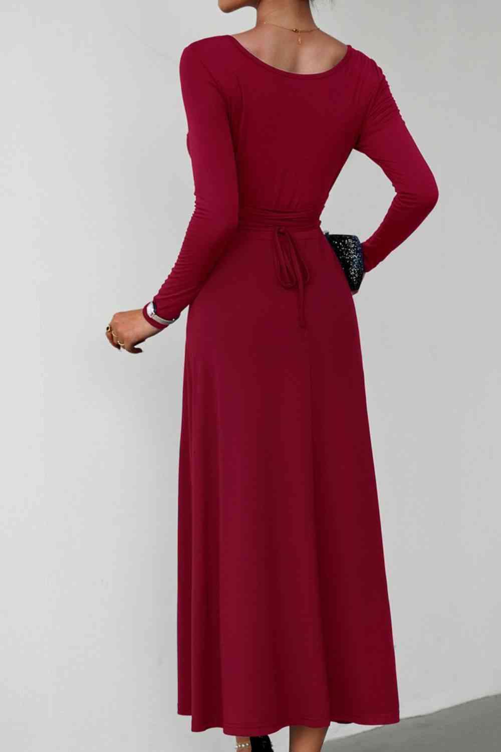 a woman in a red dress with her hands on her hips