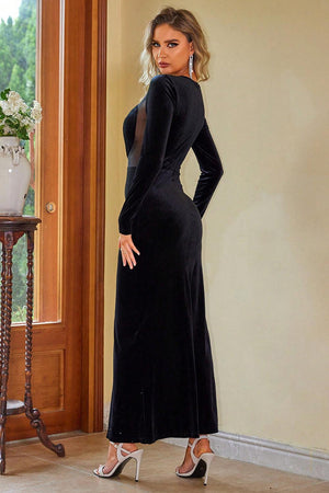 a woman in a black dress standing in a room