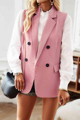 a woman wearing a pink blazer and shorts