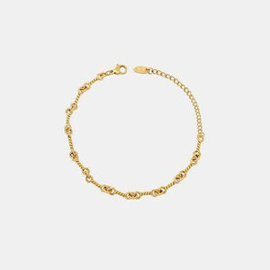 a gold bracelet on a white background