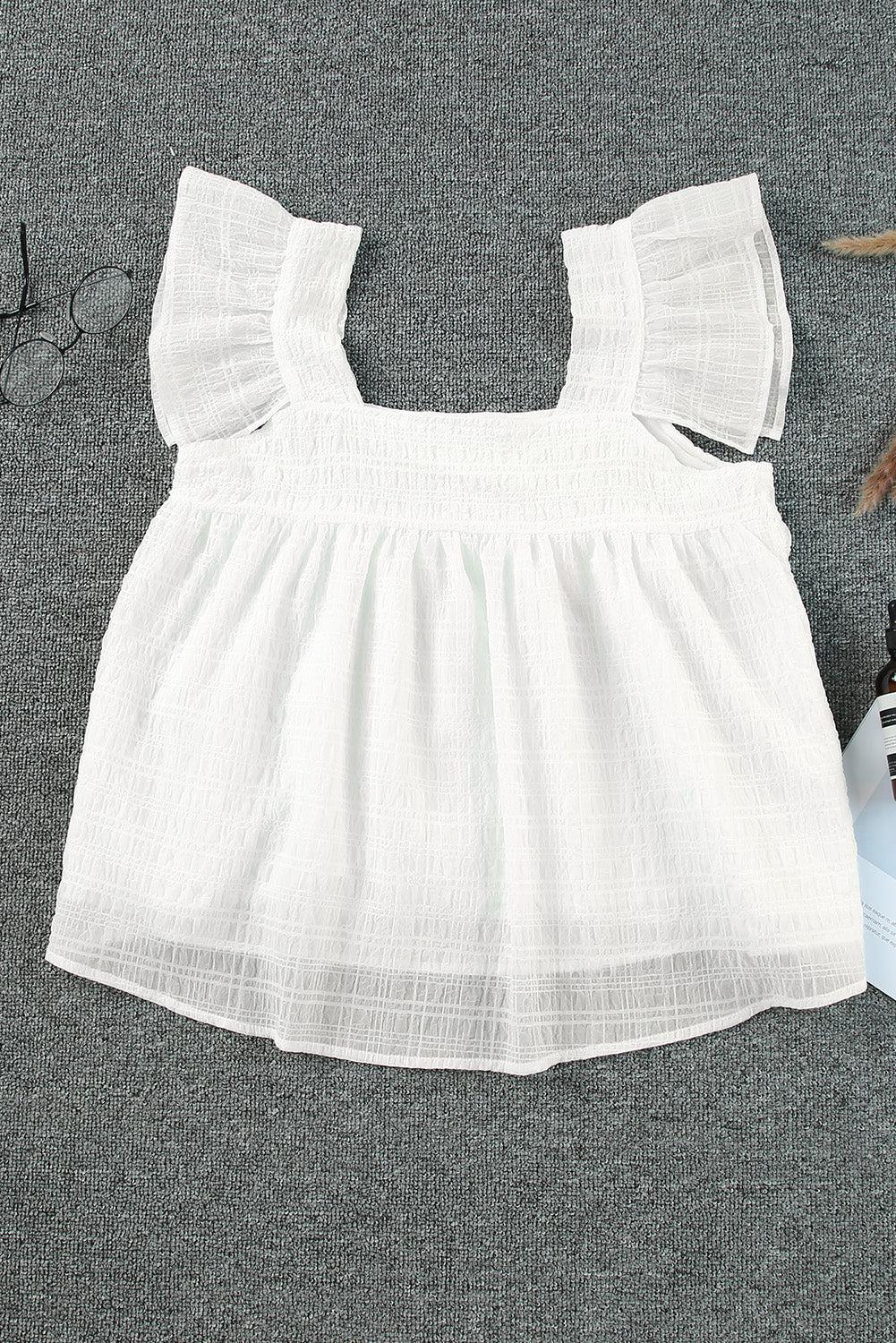 a baby girl's white dress next to a pair of scissors