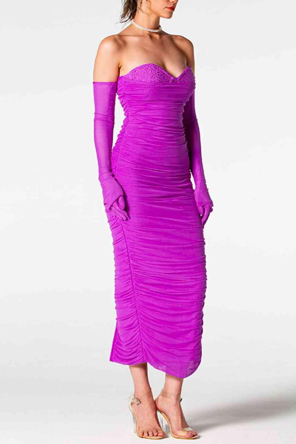 a woman in a purple dress is posing for a picture