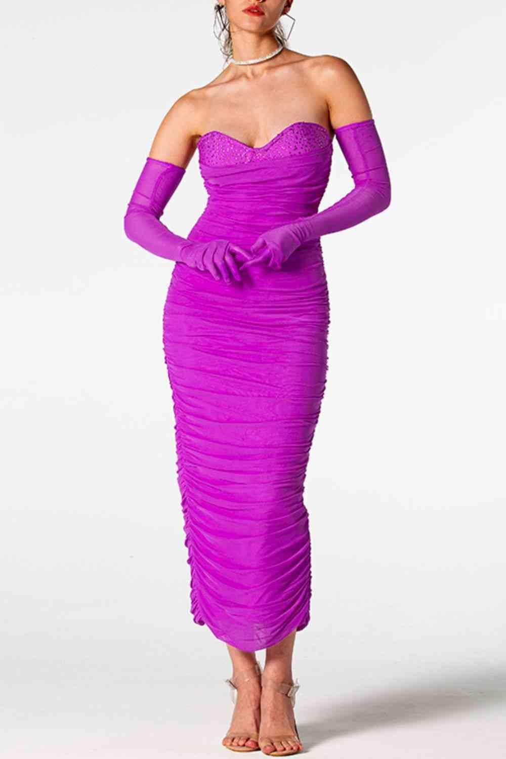 a woman wearing a purple dress and gloves